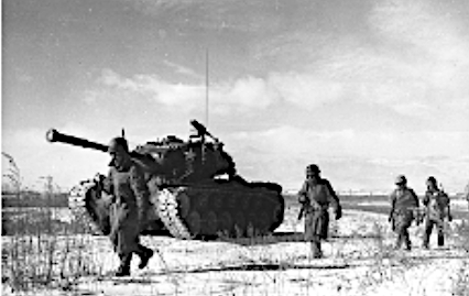 Men walking with a tank in the Korea war